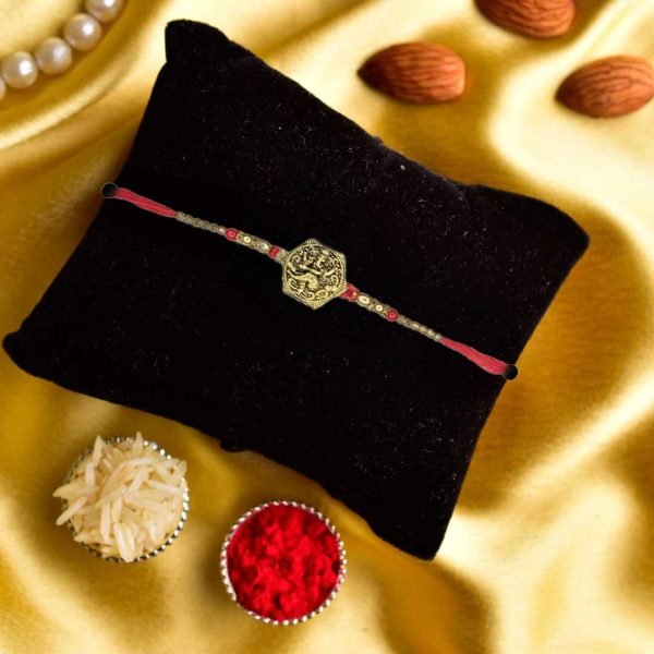 Antique Style Ganesha Rakhi with Red and Golden Beads