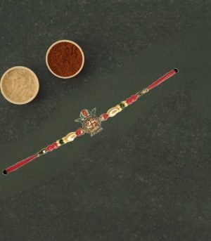 Elegant Metal Kalash Rakhi with red and golden beads