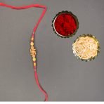 Golden Swastik Rakhi with Red Beads