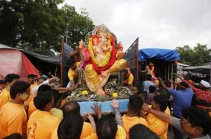 An idol of Lord Ganesha being taken for immersion